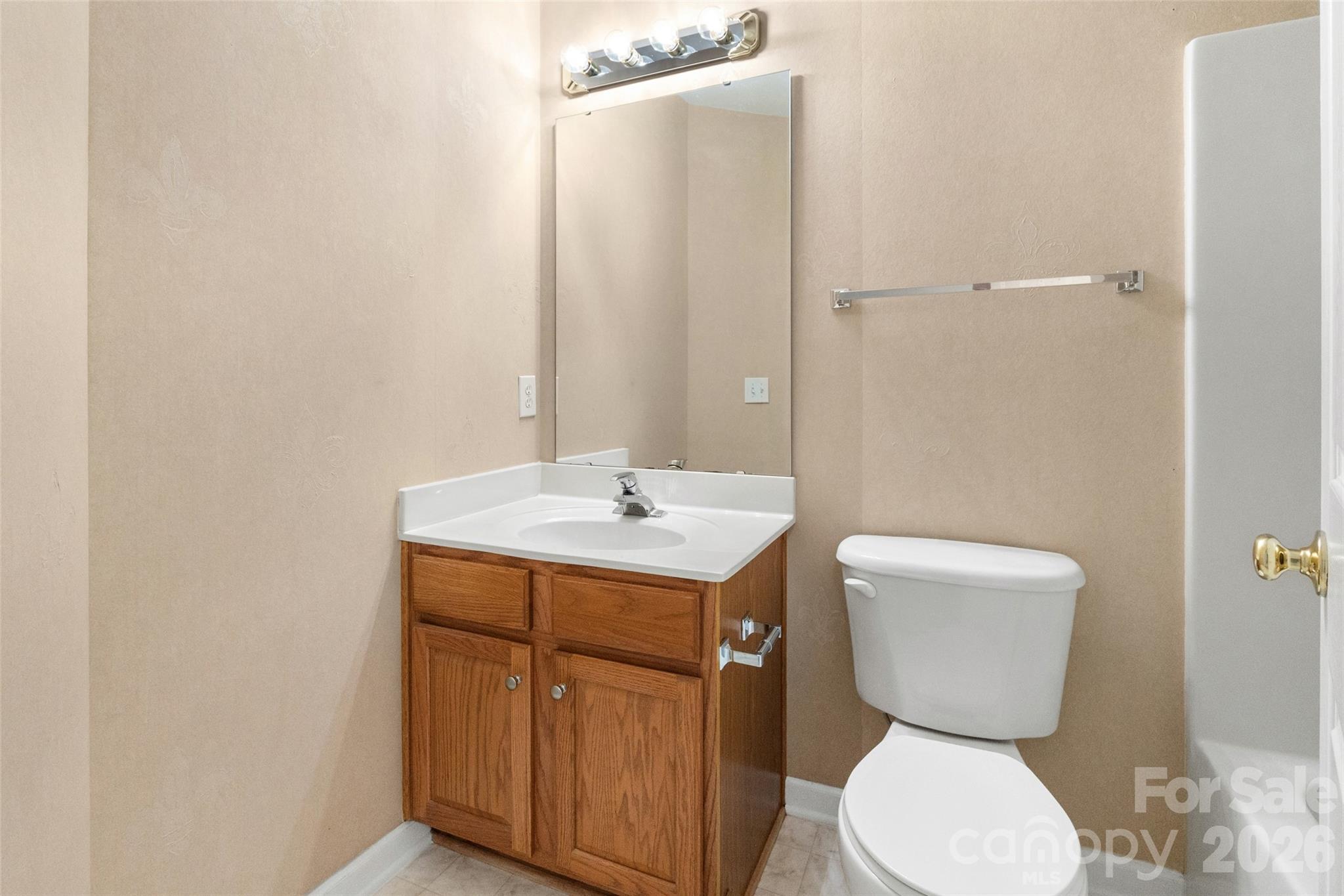 104 Rock Ridge Lane Mount Holly, NC 28120 - Photo 39 of 48 a bathroom with a toilet sink and mirror