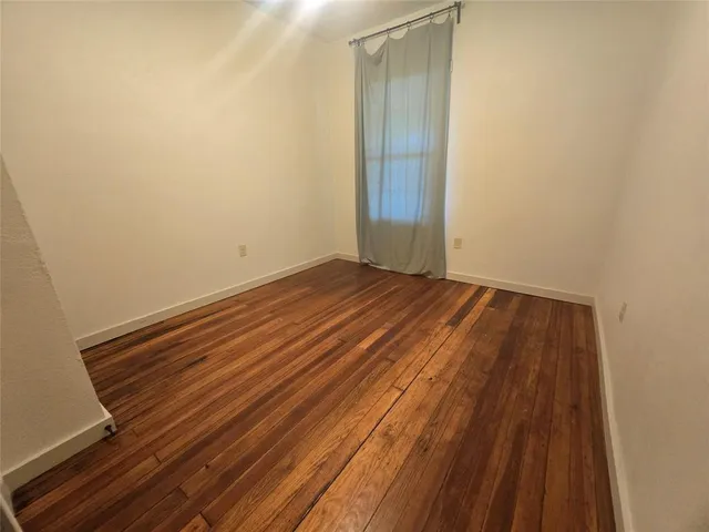 a view of a room with wooden floor and white doors