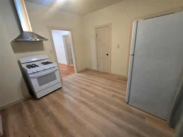 a view of a room with wooden floor and bench