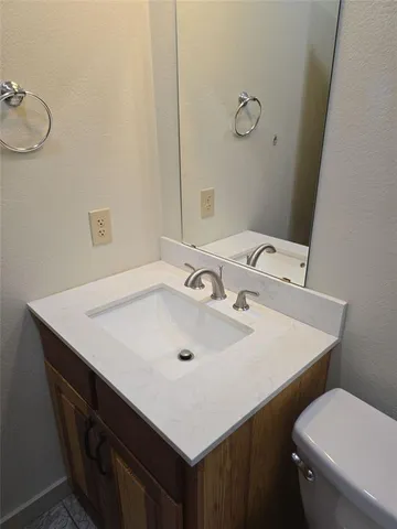 a white toilet sitting next to a bathroom sink