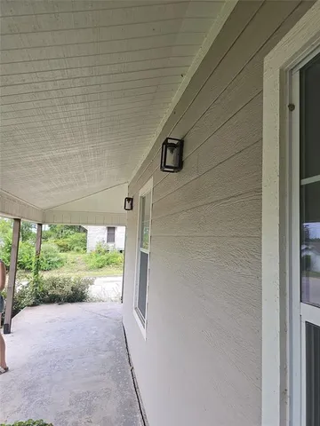 an empty room with wooden floor and closet area