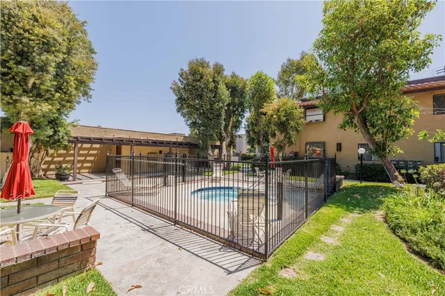 a view of a house with backyard and sitting area
