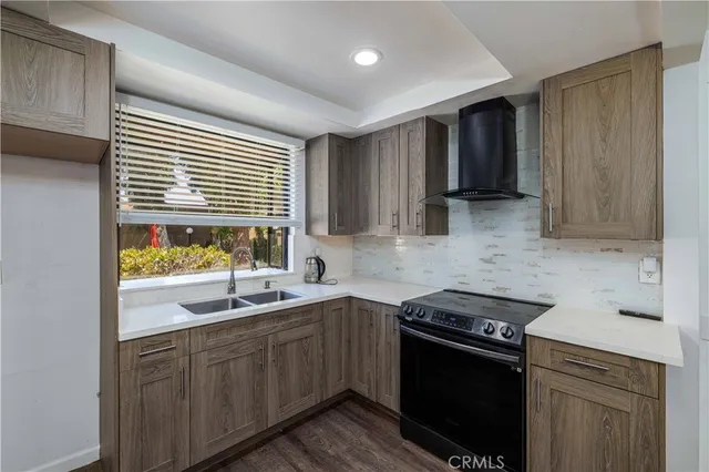a kitchen with a sink stove top oven and cabinets