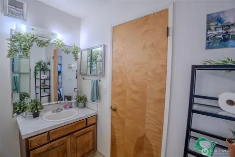 a room with stainless steel appliances kitchen island granite countertop furniture and a rug