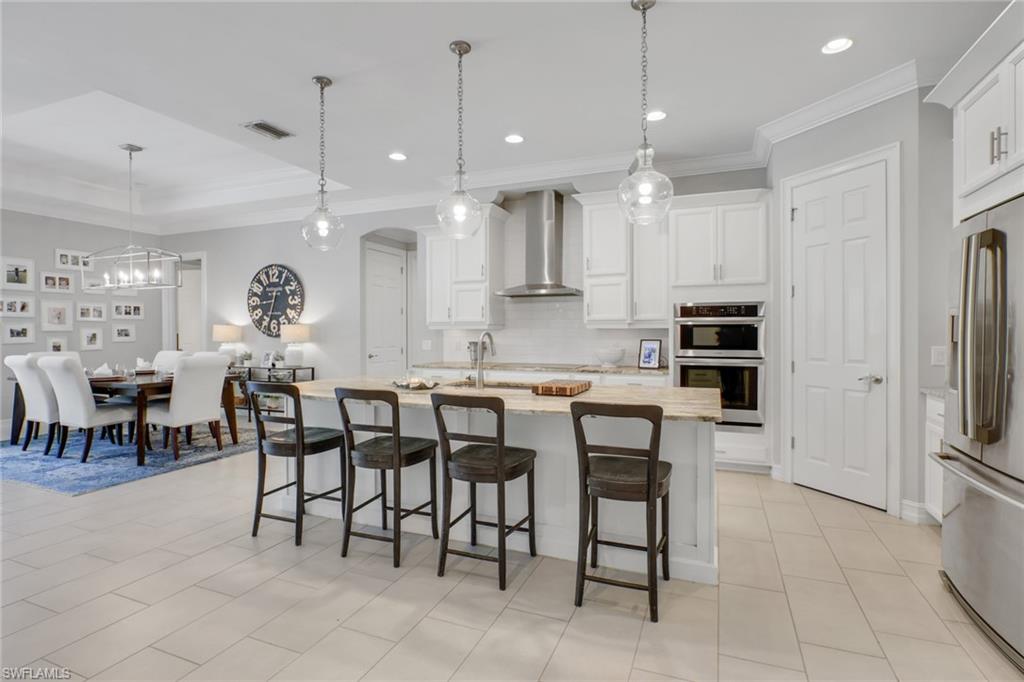1511 Mockingbird Drive Naples, FL 34120 - Photo 11 of 44 a large kitchen with a table and chairs