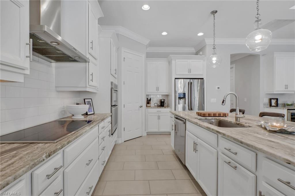 1511 Mockingbird Drive Naples, FL 34120 - Photo 13 of 44 a large kitchen with a sink and cabinets