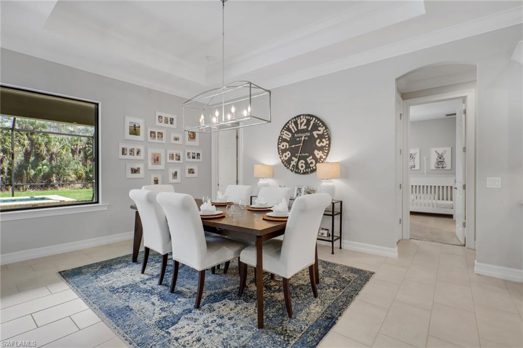 1511 Mockingbird Drive Naples, FL 34120 - Photo 14 of 44 a view of a dining room with furniture window and wooden floor