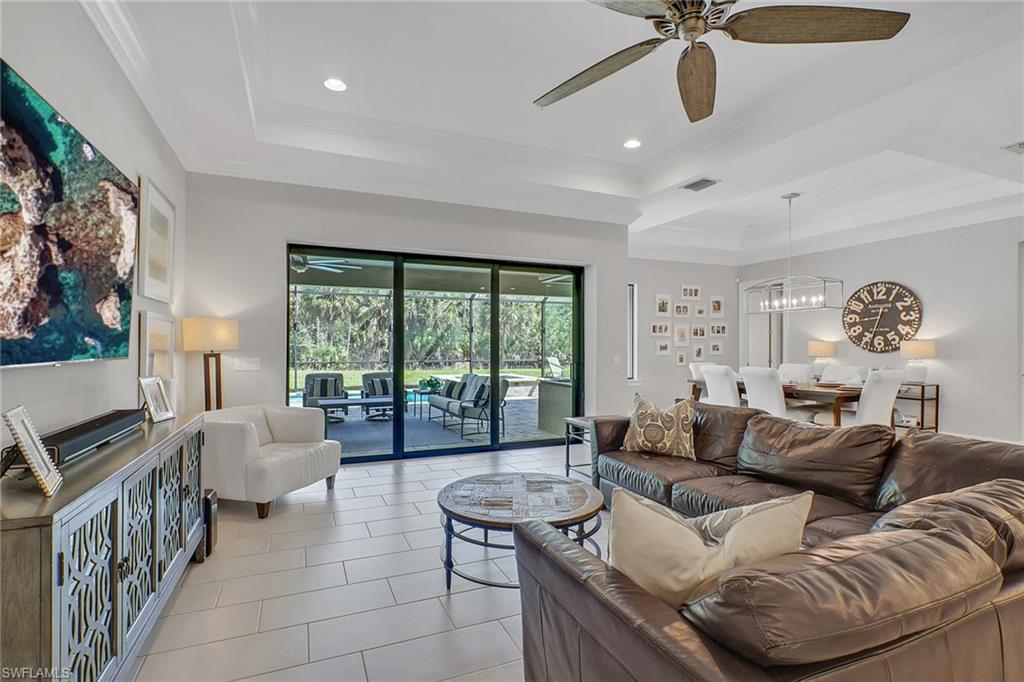 1511 Mockingbird Drive Naples, FL 34120 - Photo 16 of 44 a living room with furniture and a large window