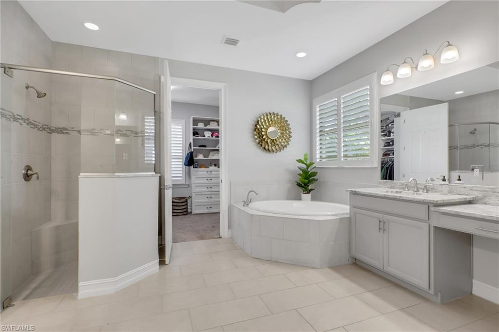 1511 Mockingbird Drive Naples, FL 34120 - Photo 19 of 44 a bathroom with a bathtub a sink a mirror and a shower