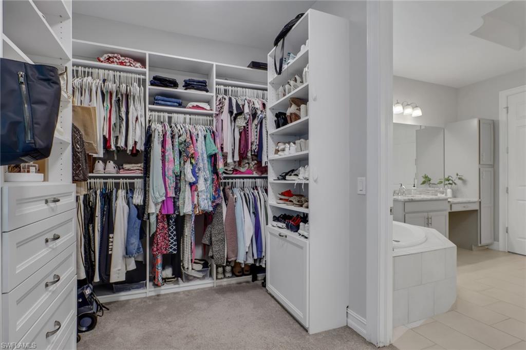 1511 Mockingbird Drive Naples, FL 34120 - Photo 20 of 44 a view of walk in closet with clothes