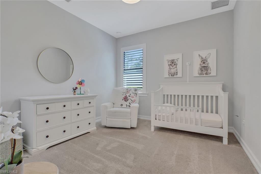 1511 Mockingbird Drive Naples, FL 34120 - Photo 22 of 44 a bedroom with furniture and a baby crib