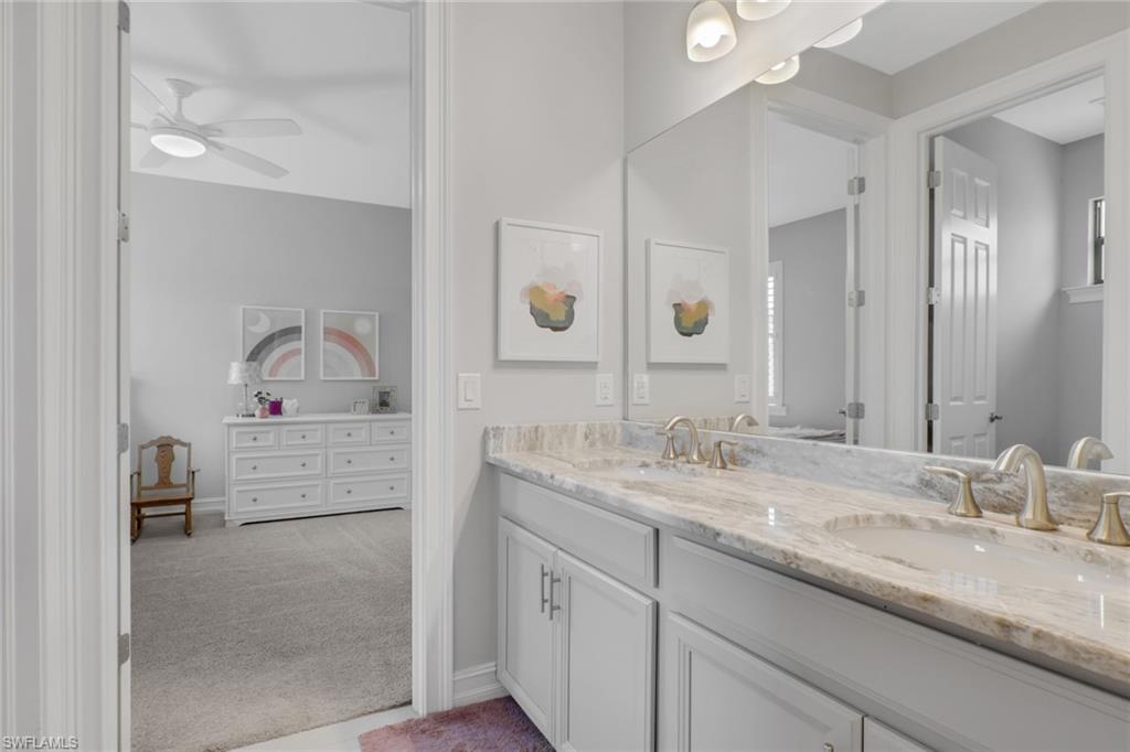 1511 Mockingbird Drive Naples, FL 34120 - Photo 24 of 44 a bathroom with a sink and a mirror