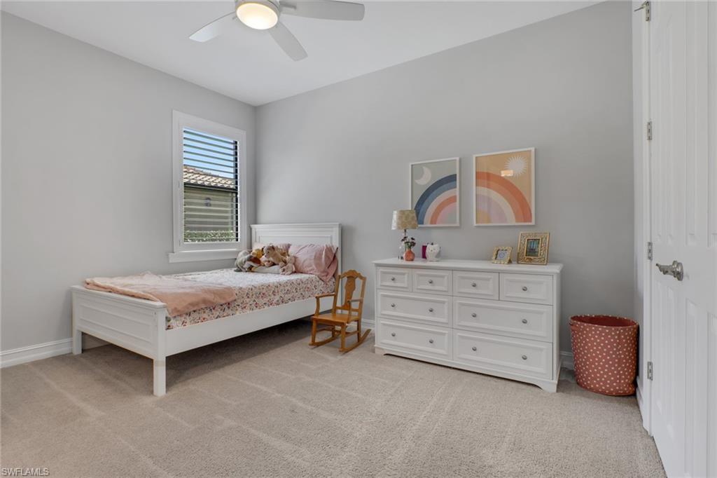 1511 Mockingbird Drive Naples, FL 34120 - Photo 27 of 44 a bedroom with a bed and a chandelier