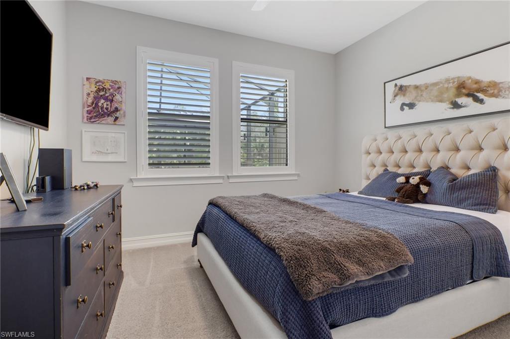 1511 Mockingbird Drive Naples, FL 34120 - Photo 29 of 44 a bedroom with a bed and a flat screen tv