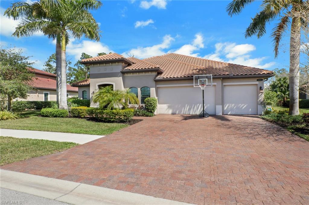 1511 Mockingbird Drive Naples, FL 34120 - Photo 3 of 44 a view of a house with a yard and palm trees