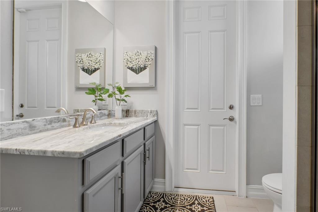 1511 Mockingbird Drive Naples, FL 34120 - Photo 31 of 44 a bathroom with a granite countertop sink and a mirror