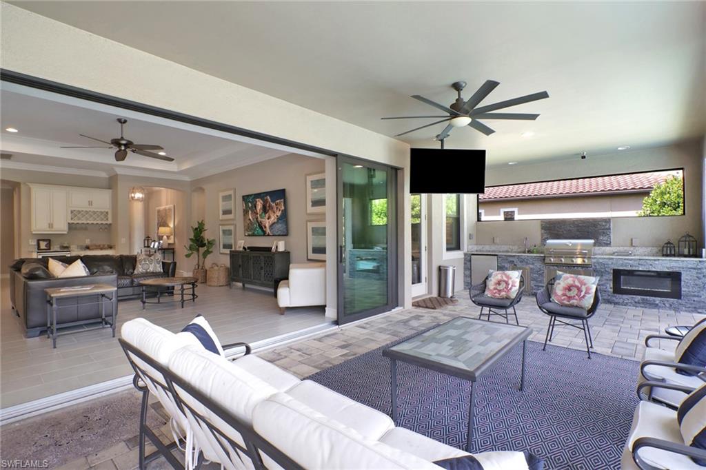 1511 Mockingbird Drive Naples, FL 34120 - Photo 32 of 44 a living room with furniture a flat screen tv and kitchen view