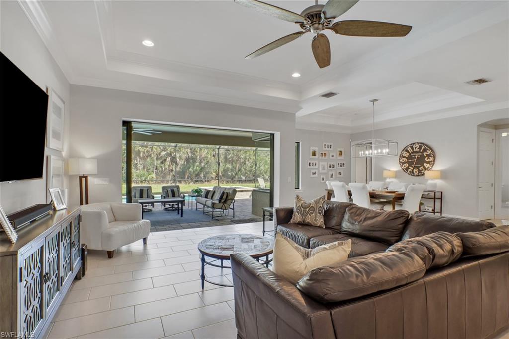 1511 Mockingbird Drive Naples, FL 34120 - Photo 33 of 44 a living room with furniture and a flat screen tv