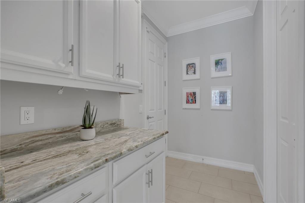 1511 Mockingbird Drive Naples, FL 34120 - Photo 10 of 44 a kitchen with granite countertop white cabinets and a sink