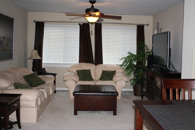 8251 Ripple Ridge Darien, IL 60561 - Photo 8 of 24 a living room with furniture a large window and a flat screen tv