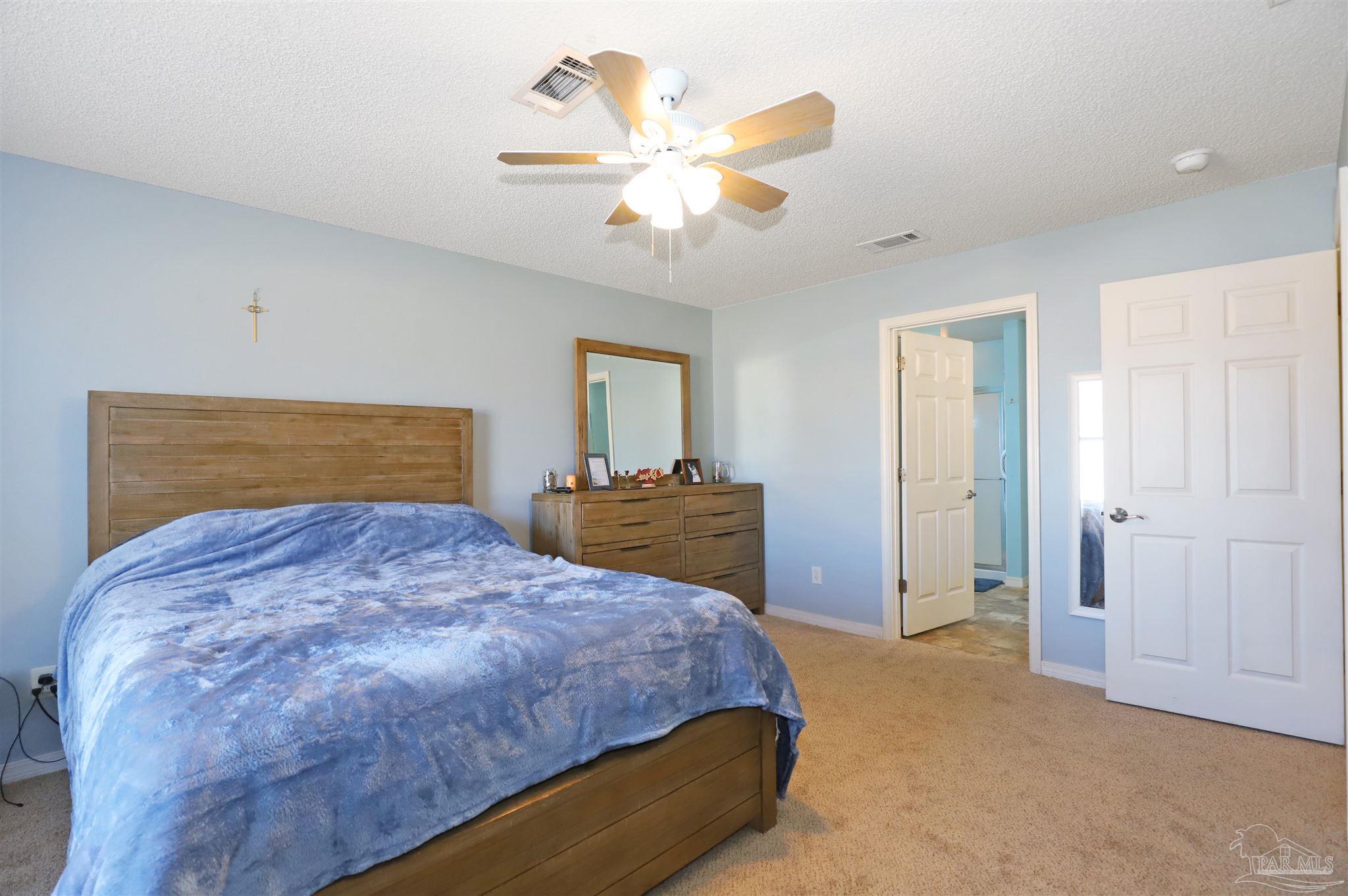 6006 Patch Lane Pensacola, FL 32526 - Photo 14 of 32 a bedroom with a bed and a chandelier