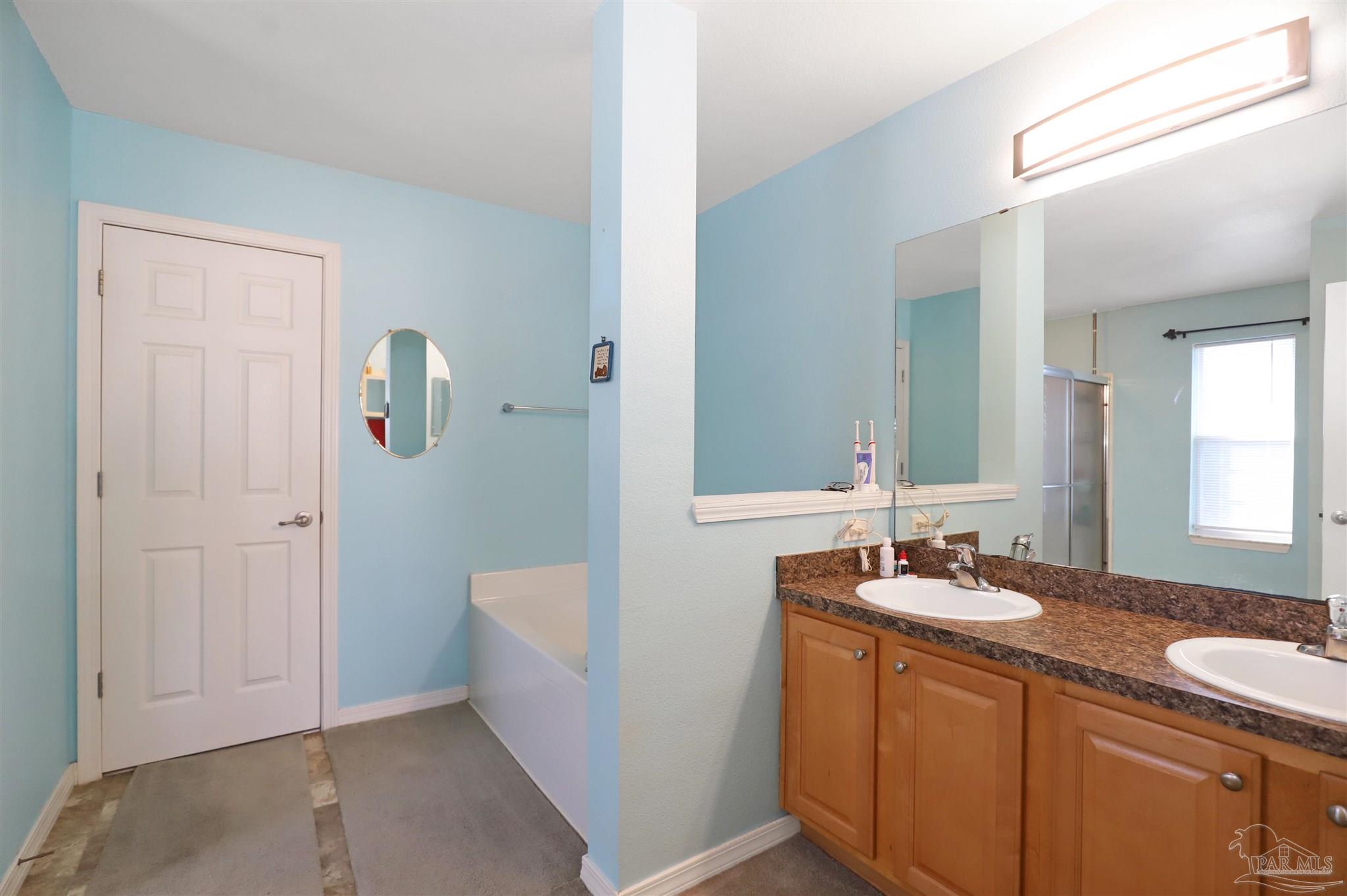6006 Patch Lane Pensacola, FL 32526 - Photo 15 of 32 a bathroom with a sink and a mirror