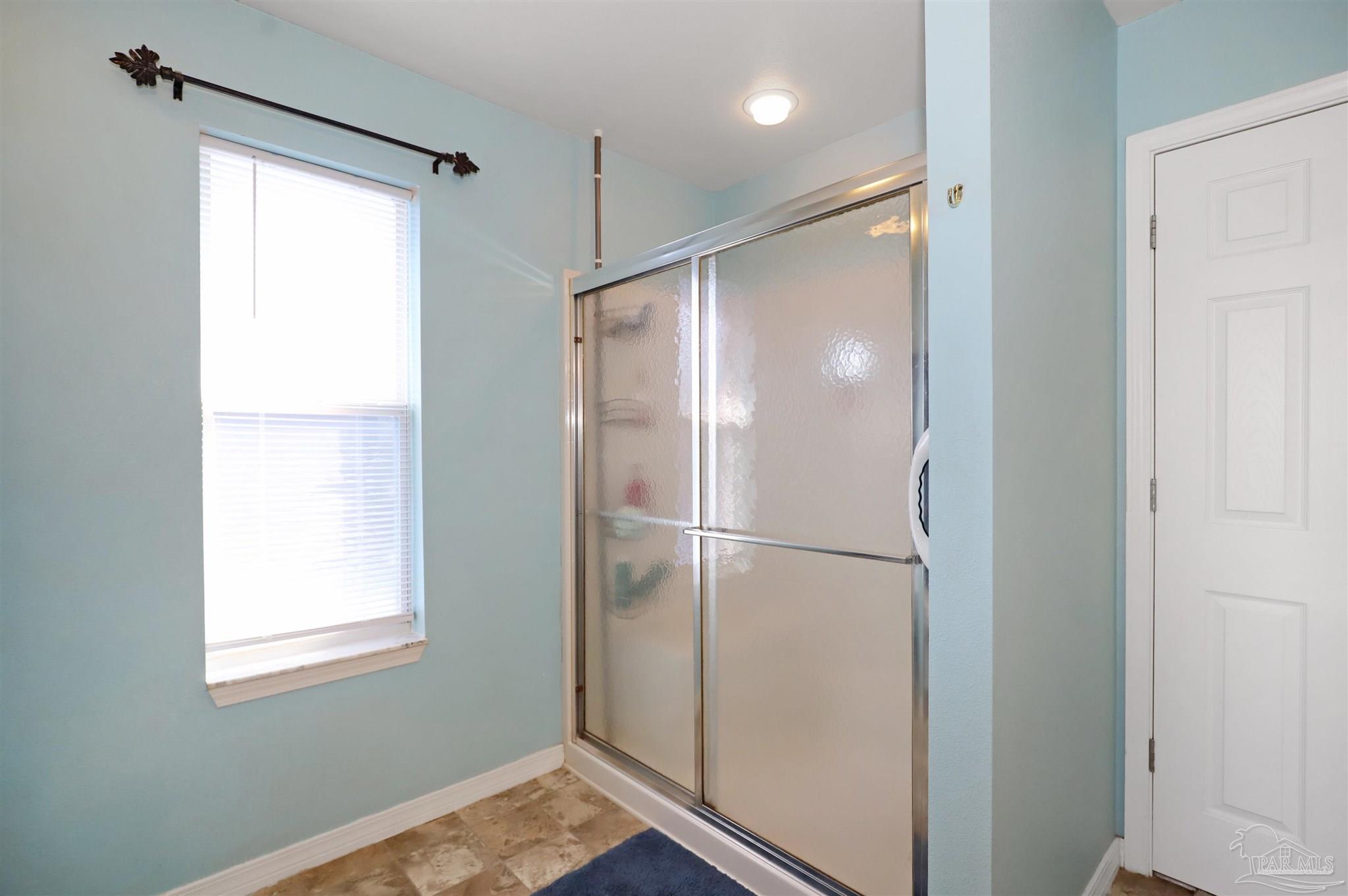 6006 Patch Lane Pensacola, FL 32526 - Photo 16 of 32 a bathroom with a shower and a window