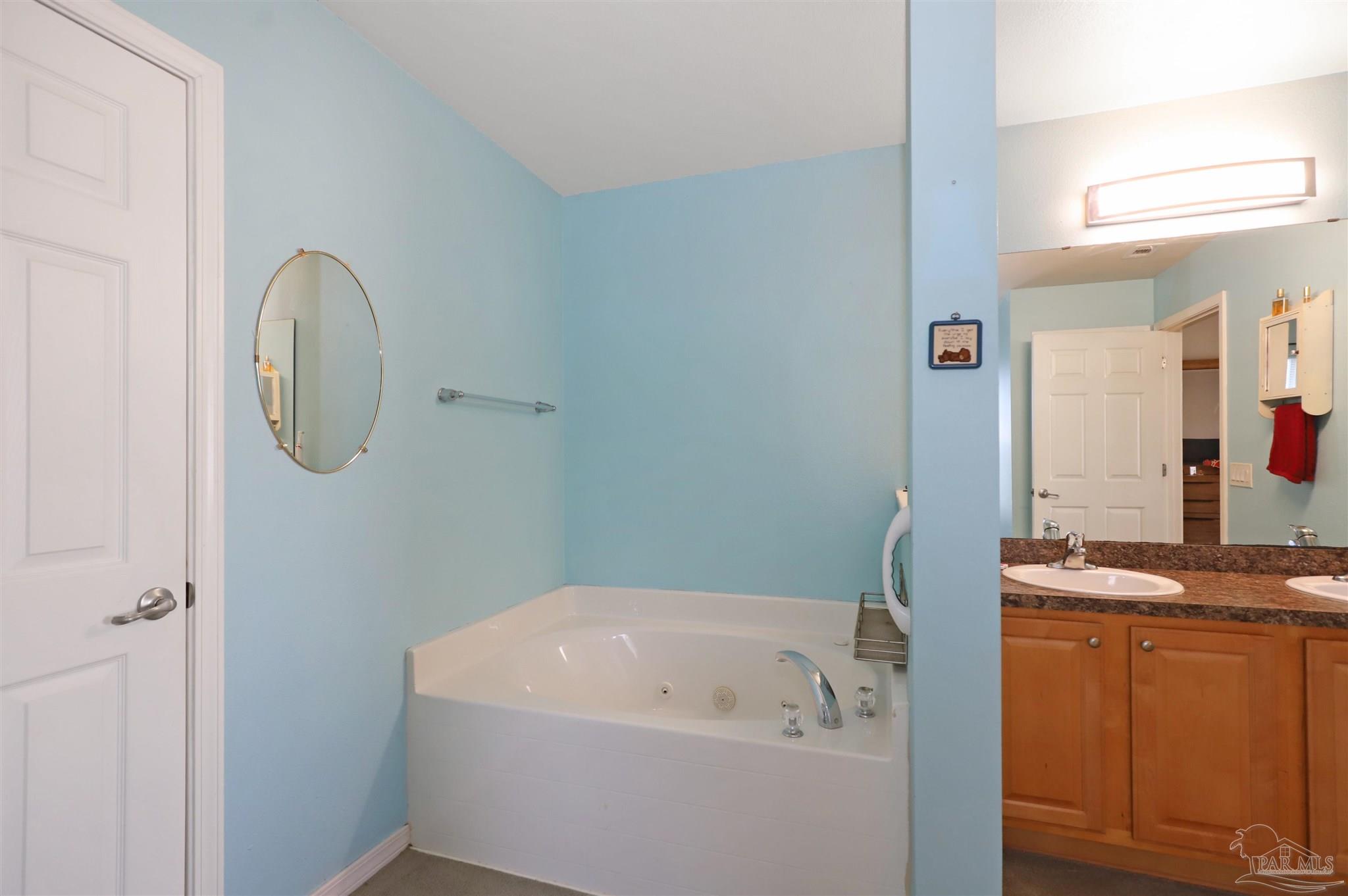 6006 Patch Lane Pensacola, FL 32526 - Photo 17 of 32 a bathroom with a granite countertop sink and a mirror