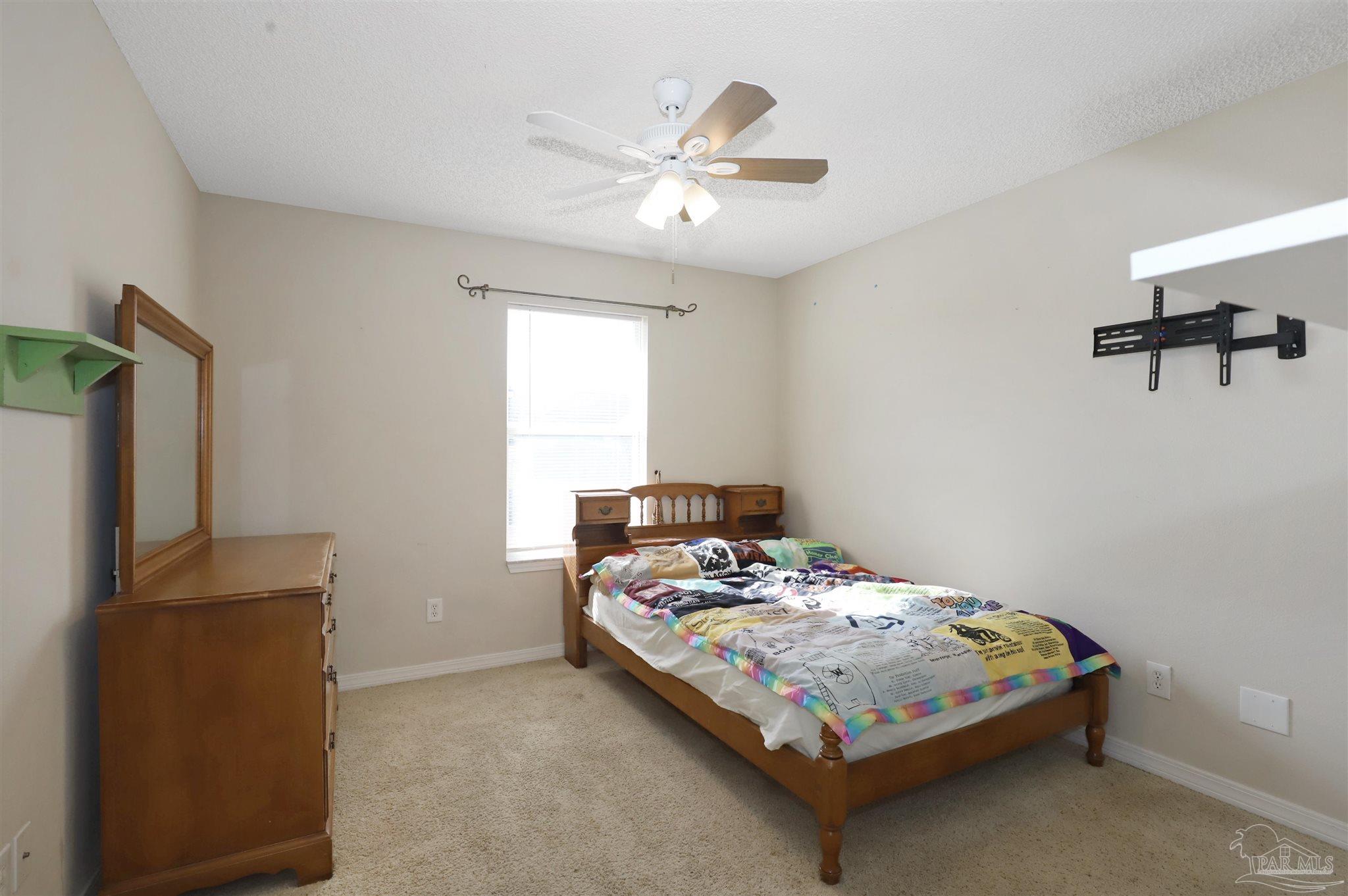 6006 Patch Lane Pensacola, FL 32526 - Photo 20 of 32 a bedroom with a bed and a flat screen tv