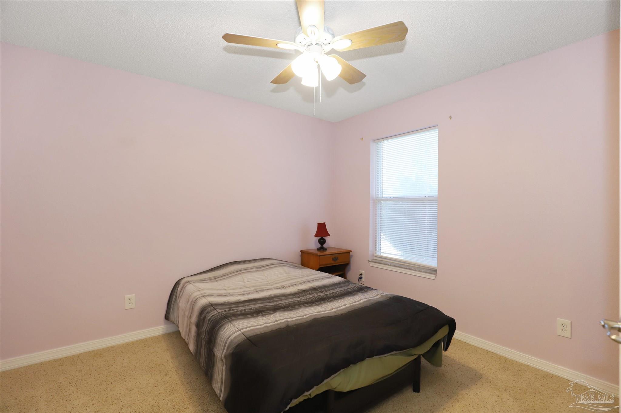 6006 Patch Lane Pensacola, FL 32526 - Photo 21 of 32 a bedroom with a bed and a chandelier