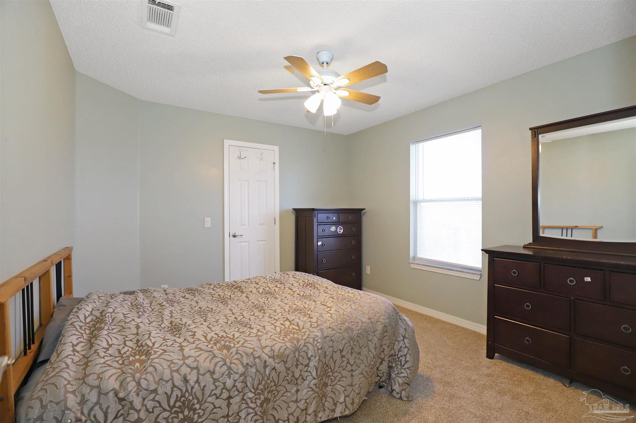 6006 Patch Lane Pensacola, FL 32526 - Photo 22 of 32 a bedroom with a bed and a window