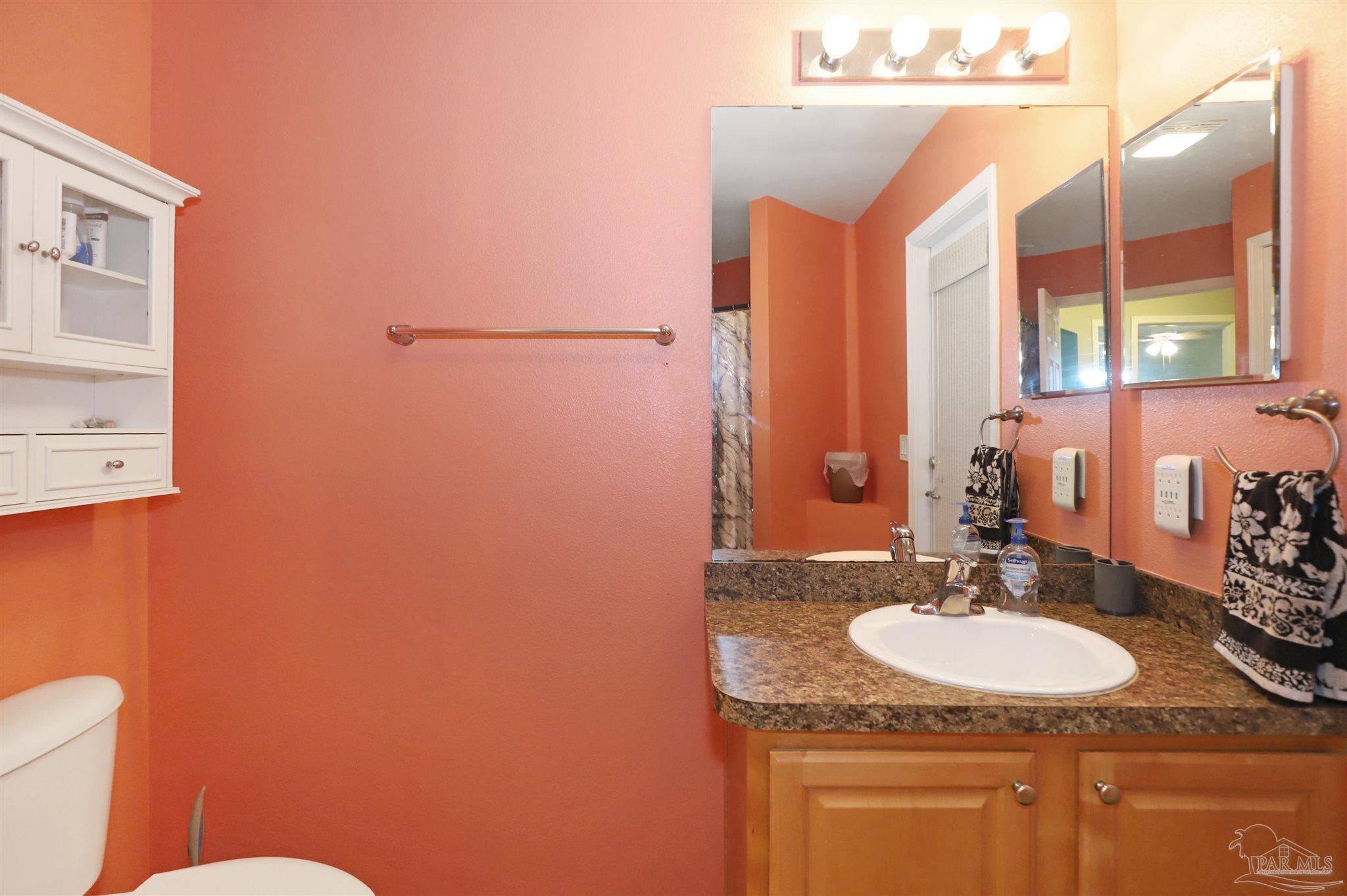 6006 Patch Lane Pensacola, FL 32526 - Photo 24 of 32 a bathroom with a sink and a mirror
