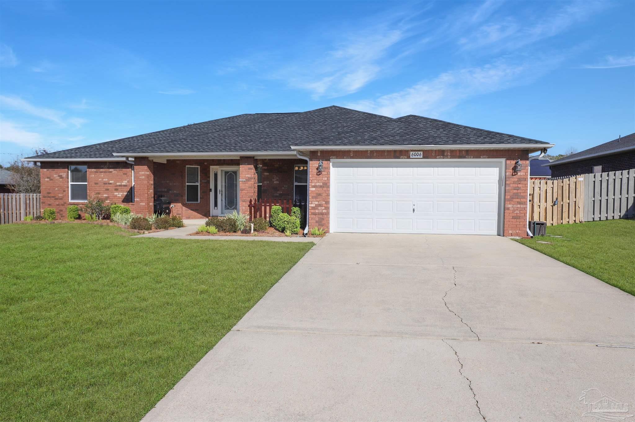 6006 Patch Lane Pensacola, FL 32526 - Photo 31 of 32 a front view of a house with a garden and yard