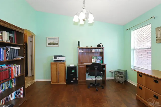 a view of a workspace with furniture and a bookshelf