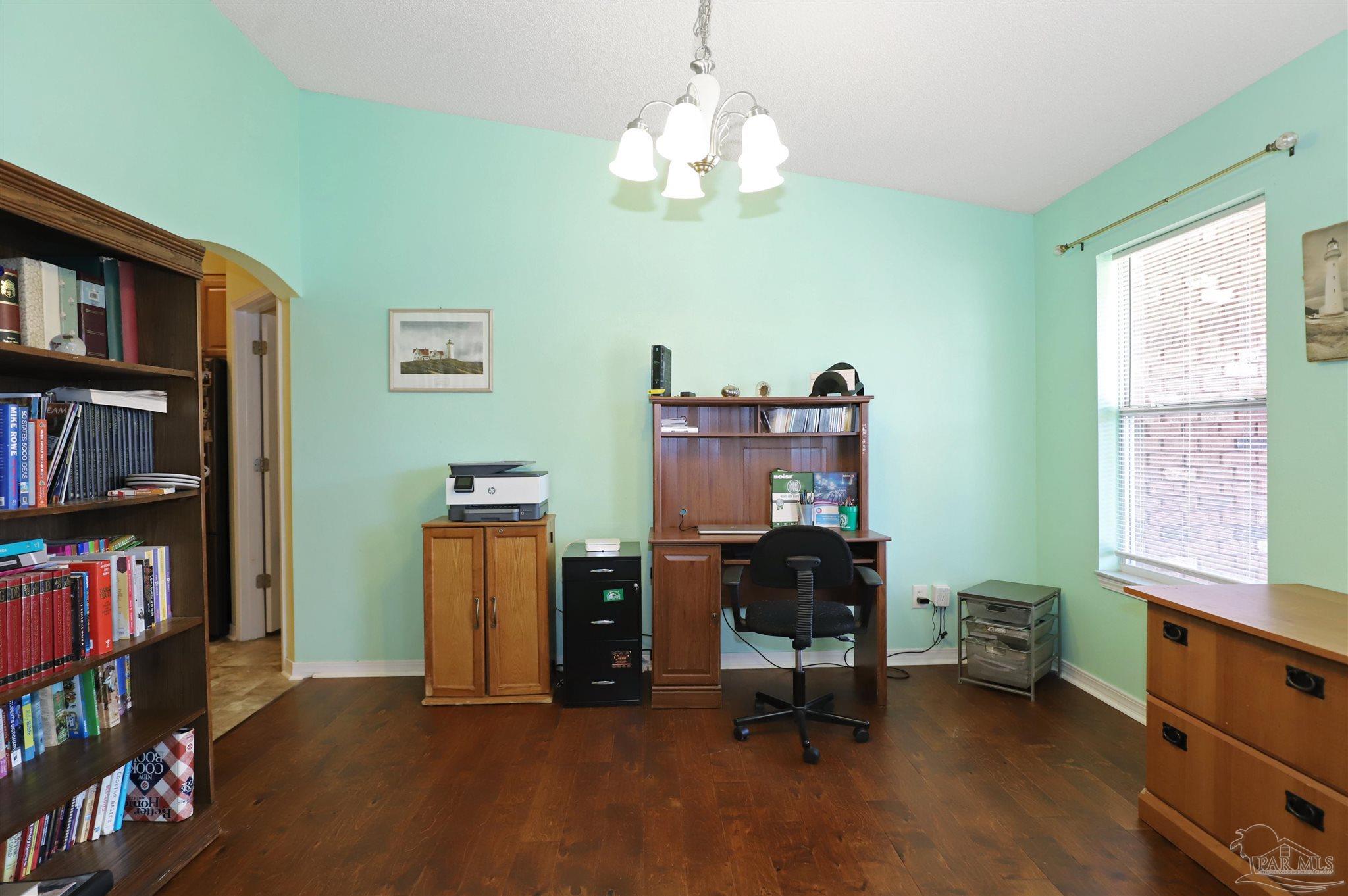 6006 Patch Lane Pensacola, FL 32526 - Photo 8 of 32 a view of a workspace with furniture and a bookshelf