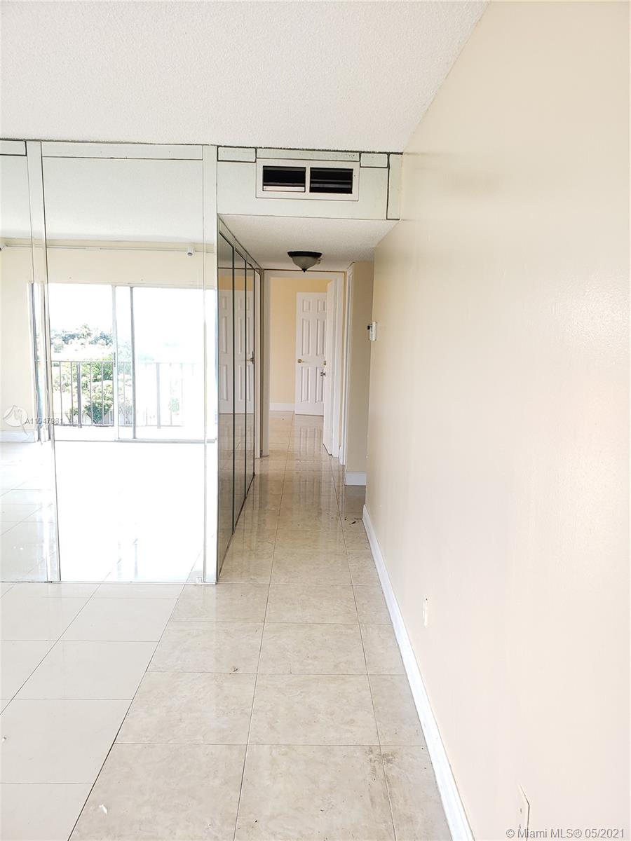 4174 Inverrary Drive, Unit 702 Lauderhill, FL 33319 - Photo 2 of 17 a view of a hallway with wooden floor and entryway