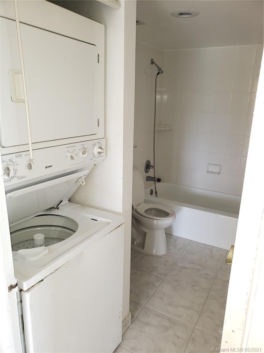 4174 Inverrary Drive, Unit 702 Lauderhill, FL 33319 - Photo 12 of 17 a bathroom with a sink a toilet and shower