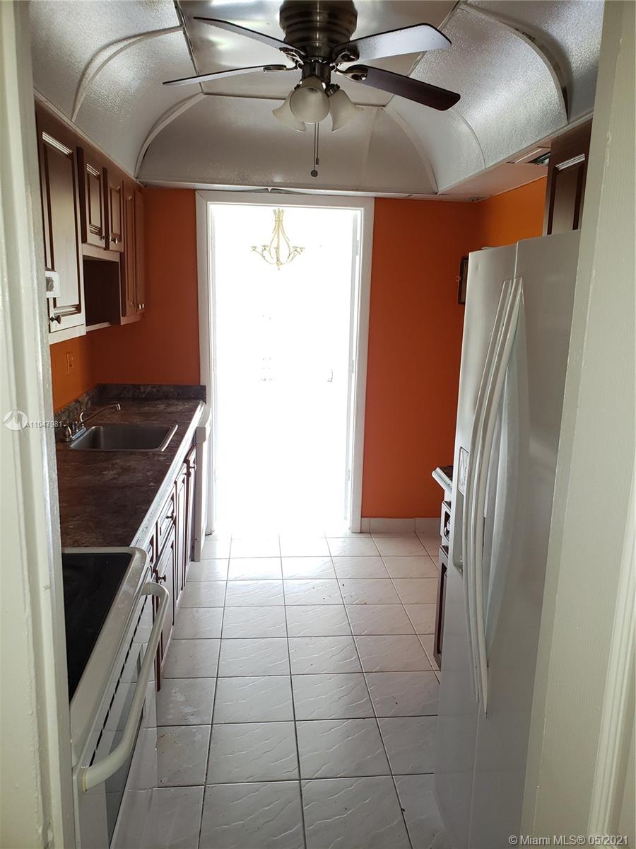 4174 Inverrary Drive, Unit 702 Lauderhill, FL 33319 - Photo 14 of 17 a kitchen with stainless steel appliances granite countertop a refrigerator and a stove