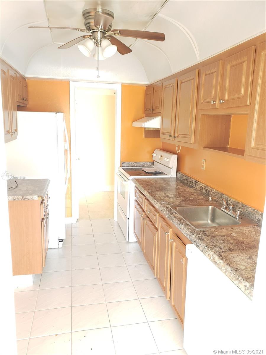 4174 Inverrary Drive, Unit 702 Lauderhill, FL 33319 - Photo 5 of 17 a kitchen with stainless steel appliances granite countertop a sink and a stove