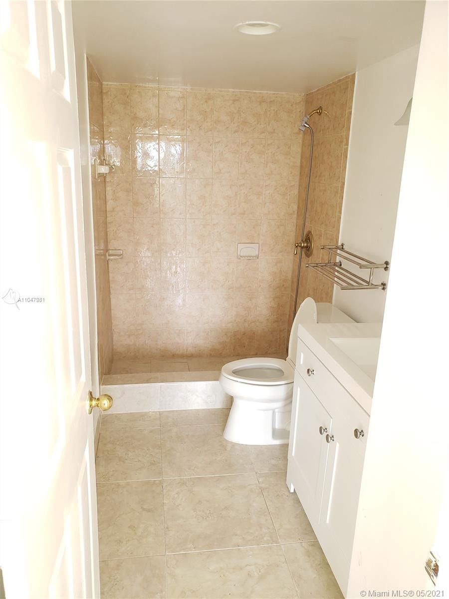 4174 Inverrary Drive, Unit 702 Lauderhill, FL 33319 - Photo 7 of 17 a bathroom with a toilet and shower