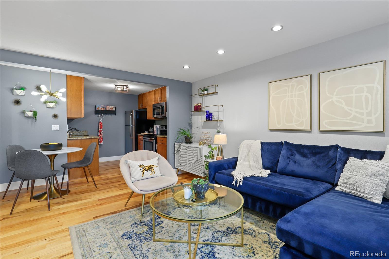 a living room with furniture and a dining table