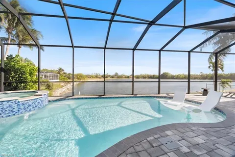 a view of a swimming pool with a lawn chairs