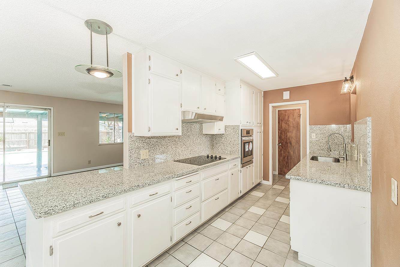 1375 South Cyrier Avenue Reedley, CA 93654 - Photo 11 of 34 a large bathroom with a granite countertop sink a toilet a mirror and shower