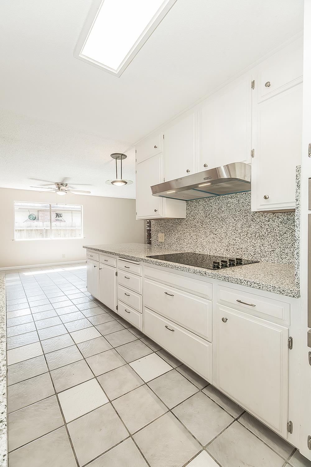 1375 South Cyrier Avenue Reedley, CA 93654 - Photo 13 of 34 a kitchen with granite countertop white cabinets and a sink