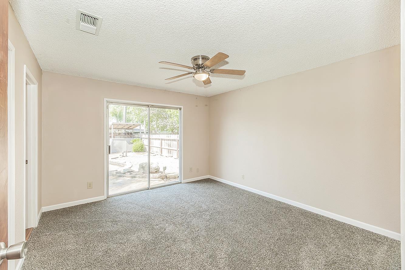 1375 South Cyrier Avenue Reedley, CA 93654 - Photo 14 of 34 an empty room with fan and windows