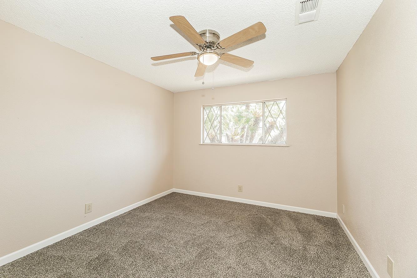 1375 South Cyrier Avenue Reedley, CA 93654 - Photo 19 of 34 an empty room with a window and a ceiling fan
