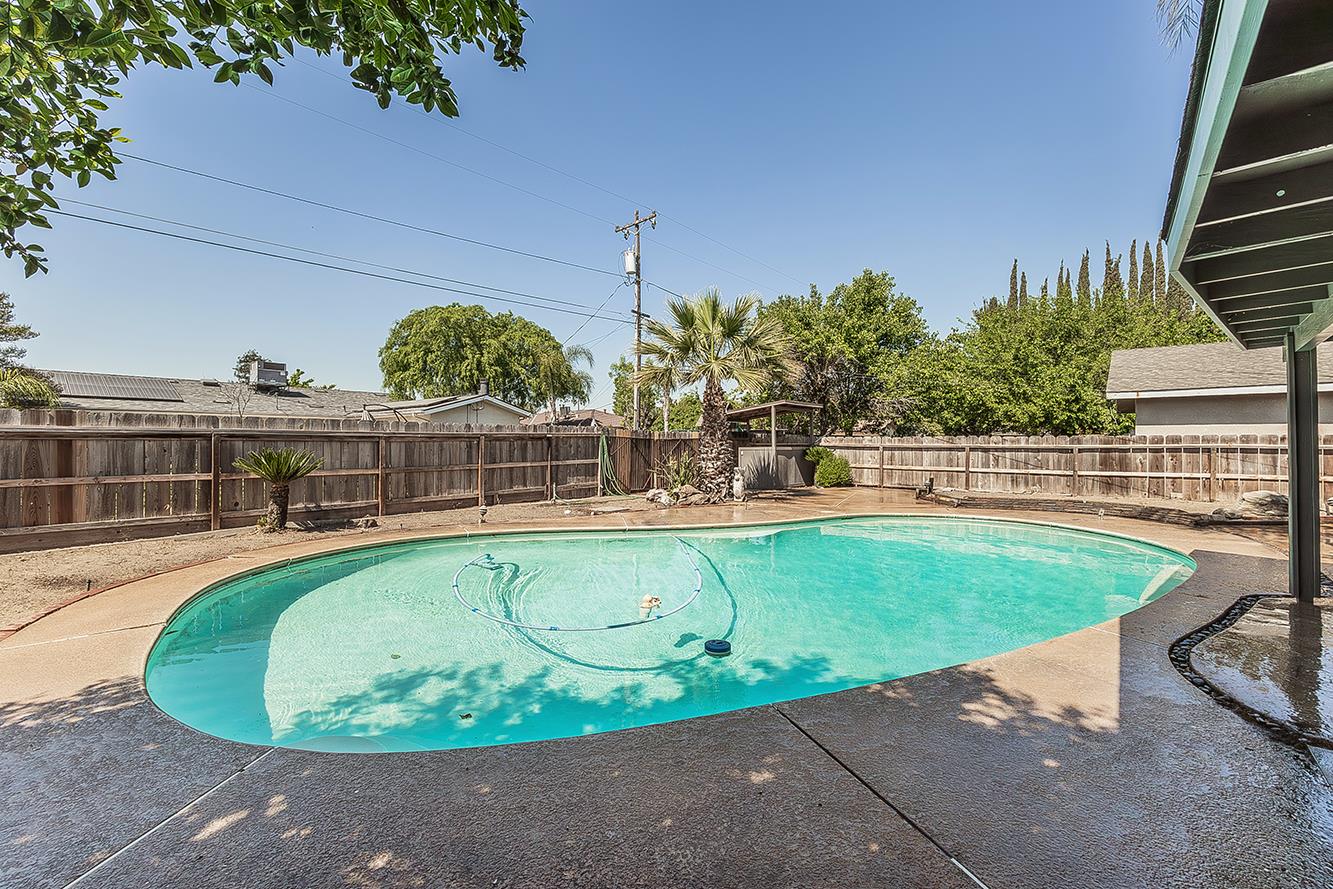 1375 South Cyrier Avenue Reedley, CA 93654 - Photo 27 of 34 a view of a swimming pool with outdoor seating and plants