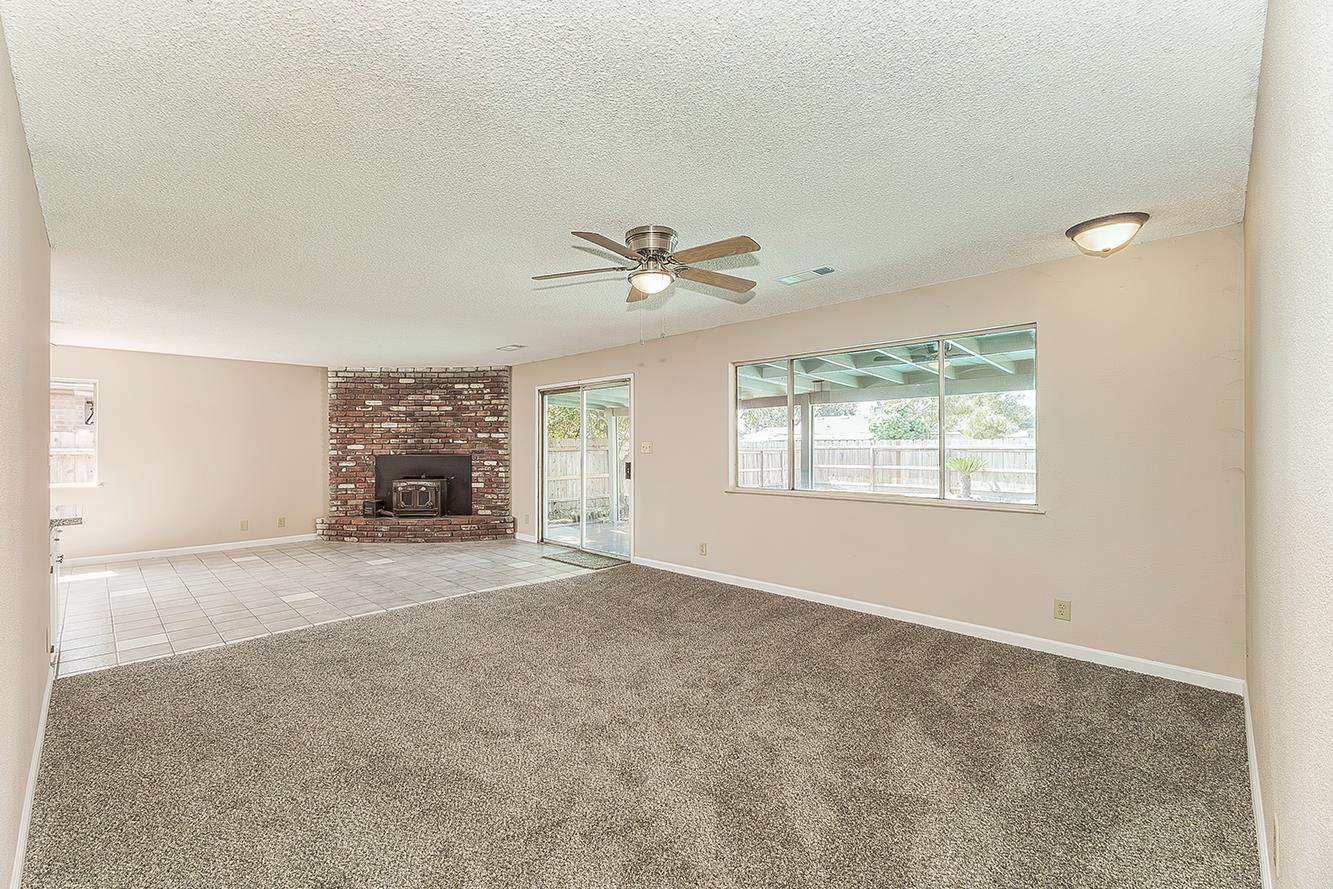 1375 South Cyrier Avenue Reedley, CA 93654 - Photo 3 of 34 an empty room with a ceiling fan and window