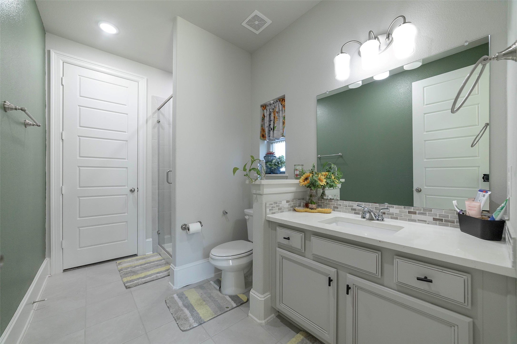 17821 Limestone Spring Lane Austin, TX 78738 - Photo 24 of 40 a spacious bathroom with a granite countertop sink a toilet and a mirror