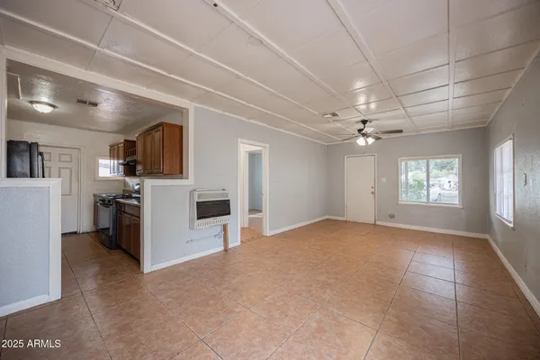 a view of a livingroom with a ceiling fan and window